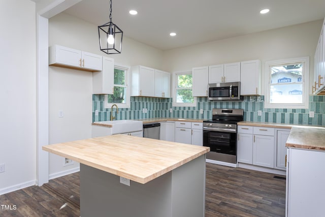 112 N Sellers St, Selma, NC 27576 - kitchen with stainless steel appliances, butcher block counters, dark wood finished floors, white cabinets, and recessed lighting