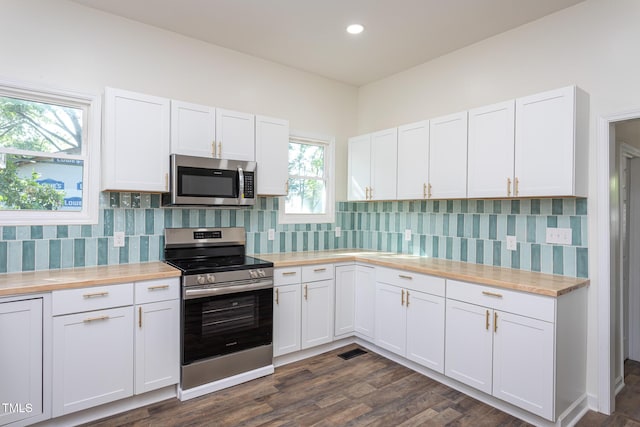 112 N Sellers St, Selma, NC 27576 - kitchen with stainless steel appliances, white cabinetry, tasteful backsplash, and recessed lighting