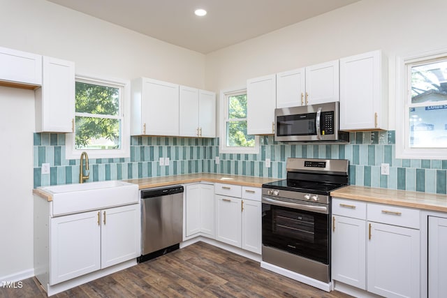 112 N Sellers St, Selma, NC 27576 - kitchen with appliances with stainless steel finishes, white cabinets, backsplash, butcher block countertops, and recessed lighting
