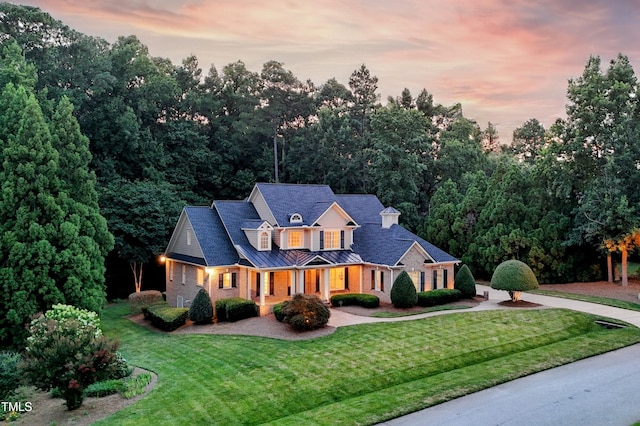 3728 Westbury Lake Dr, Raleigh, NC 27603 - view of front of home with a standing seam roof, a yard, a metal roof, and brick siding