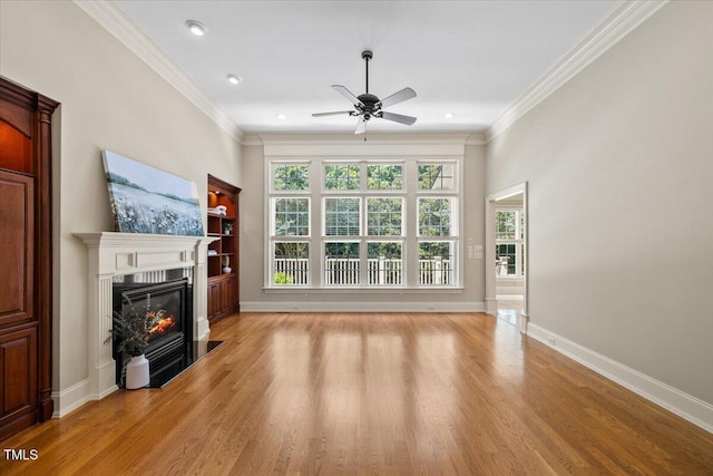 3728 Westbury Lake Dr, Raleigh, NC 27603 - unfurnished living room with a glass covered fireplace, ceiling fan, light wood finished floors, crown molding, and recessed lighting