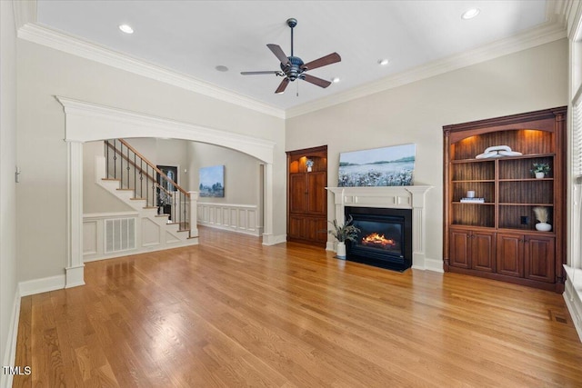 3728 Westbury Lake Dr, Raleigh, NC 27603 - unfurnished living room with a fireplace with flush hearth, wood finished floors, ceiling fan, stairway, and ornamental molding