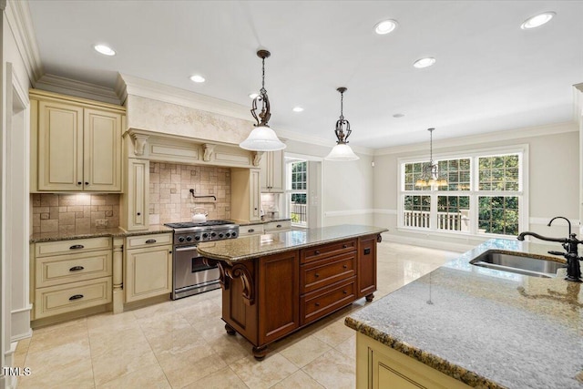 3728 Westbury Lake Dr, Raleigh, NC 27603 - kitchen featuring high end stainless steel range oven, cream cabinetry, a center island, backsplash, and crown molding