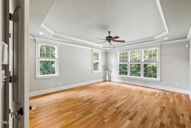 3728 Westbury Lake Dr, Raleigh, NC 27603 - spare room with a tray ceiling, crown molding, ceiling fan, light wood finished floors, and recessed lighting