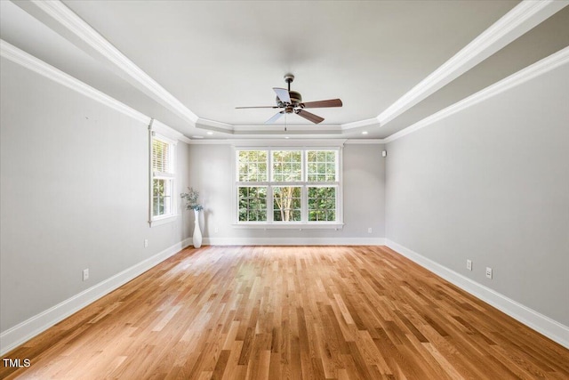 3728 Westbury Lake Dr, Raleigh, NC 27603 - empty room featuring a tray ceiling, healthy amount of natural light, ceiling fan, light wood-style floors, and ornamental molding