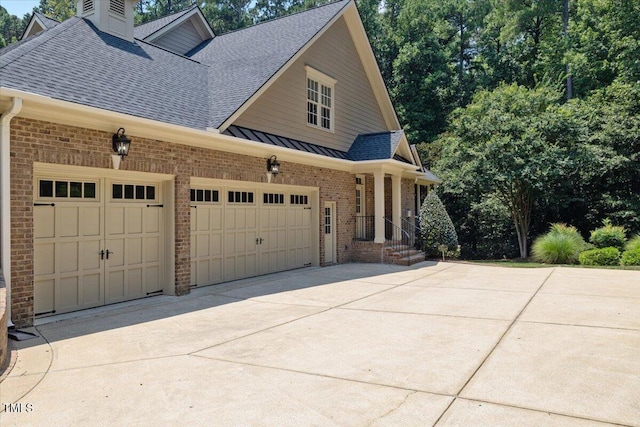 3728 Westbury Lake Dr, Raleigh, NC 27603 - view of front of property with roof with shingles, brick siding, driveway, a garage, and a standing seam roof