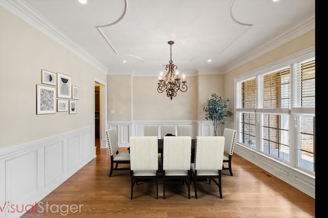 3728 Westbury Lake Dr, Raleigh, NC 27603 - dining room featuring a chandelier, crown molding, wood finished floors, recessed lighting, and a wainscoted wall