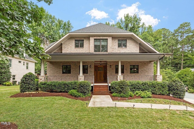 1103 Roosevelt Dr, Chapel Hill, NC 27514 - view of front facade featuring brick siding, covered porch, and a front lawn