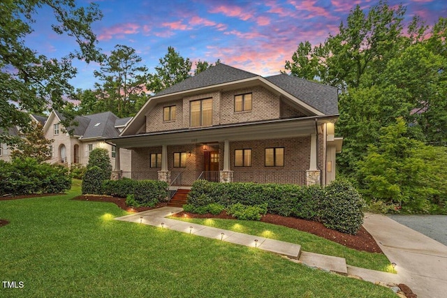 1103 Roosevelt Dr, Chapel Hill, NC 27514 - view of front facade with brick siding, covered porch, and a front lawn
