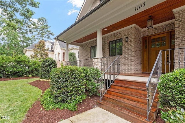 1103 Roosevelt Dr, Chapel Hill, NC 27514 - property entrance with a porch and brick siding