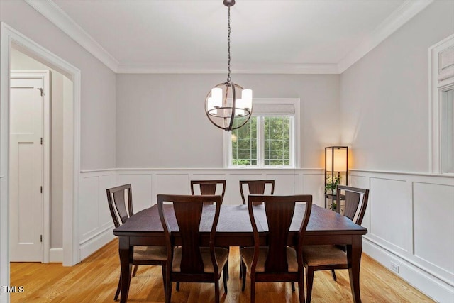 1103 Roosevelt Dr, Chapel Hill, NC 27514 - dining space featuring a chandelier, light wood-style flooring, a decorative wall, crown molding, and a wainscoted wall