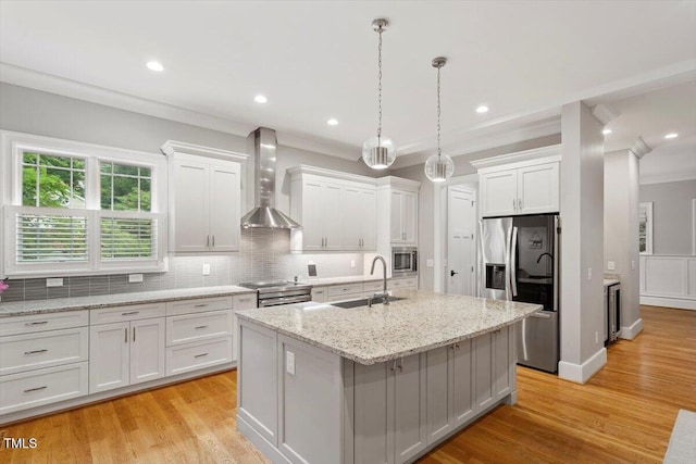 1103 Roosevelt Dr, Chapel Hill, NC 27514 - kitchen with wall chimney exhaust hood, appliances with stainless steel finishes, backsplash, an island with sink, and white cabinetry