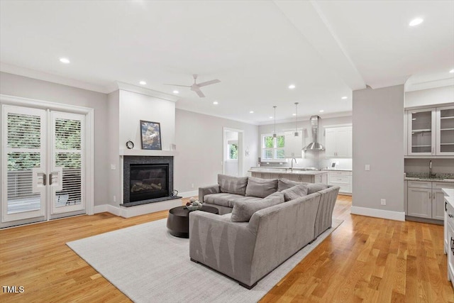 1103 Roosevelt Dr, Chapel Hill, NC 27514 - living area with a ceiling fan, light wood finished floors, recessed lighting, a glass covered fireplace, and ornamental molding
