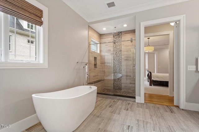 1103 Roosevelt Dr, Chapel Hill, NC 27514 - ensuite bathroom featuring a shower stall, a freestanding bath, wood finished floors, and crown molding
