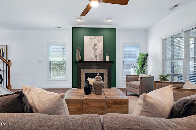837 Varina Ln, Fuquay Varina, NC 27526 - living room featuring crown molding, a fireplace, ceiling fan, and wood finished floors