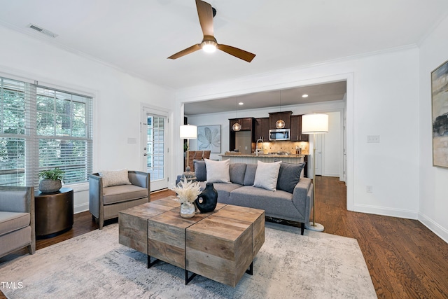 837 Varina Ln, Fuquay Varina, NC 27526 - living room featuring dark wood-style floors, ornamental molding, and a ceiling fan