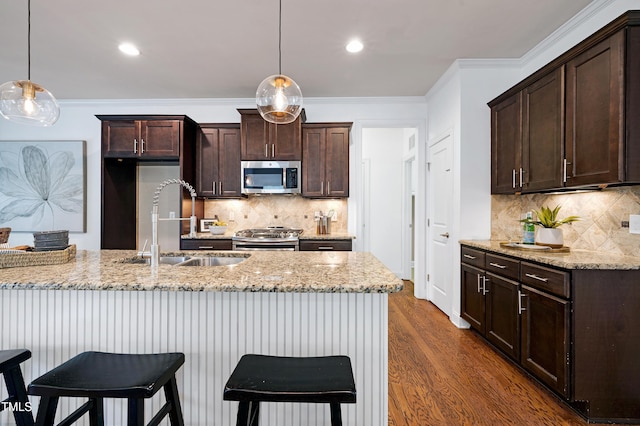 837 Varina Ln, Fuquay Varina, NC 27526 - kitchen featuring stainless steel appliances, dark brown cabinets, backsplash, light stone counters, and crown molding
