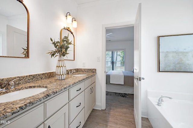 837 Varina Ln, Fuquay Varina, NC 27526 - ensuite bathroom featuring double vanity, ornamental molding, wood finished floors, and a bath