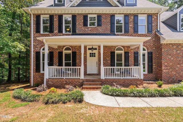 13004 Hanford Ct, Raleigh, NC 27614 - colonial house featuring a porch and brick siding