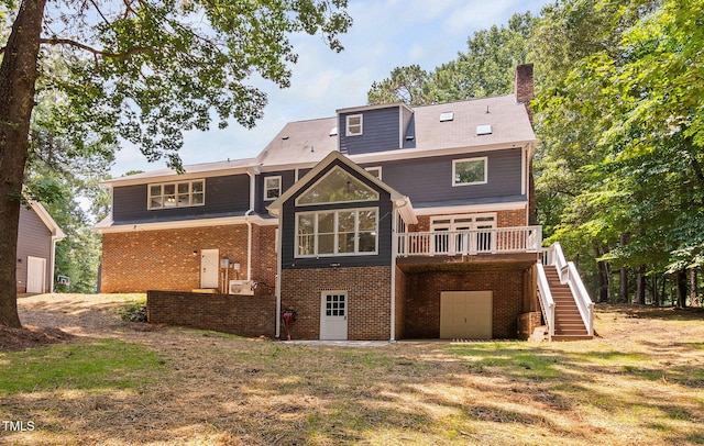 13004 Hanford Ct, Raleigh, NC 27614 - back of house with stairway, brick siding, an attached garage, a wooden deck, and a chimney