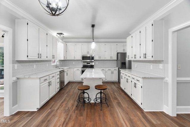 13004 Hanford Ct, Raleigh, NC 27614 - kitchen featuring appliances with stainless steel finishes, white cabinets, a chandelier, and tasteful backsplash
