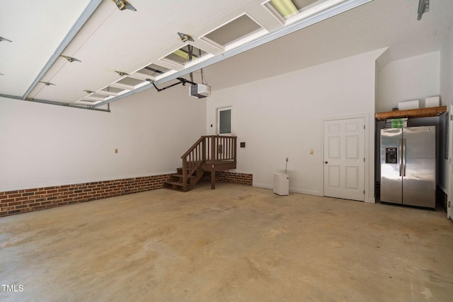 13004 Hanford Ct, Raleigh, NC 27614 - garage featuring stainless steel refrigerator with ice dispenser and a garage door opener
