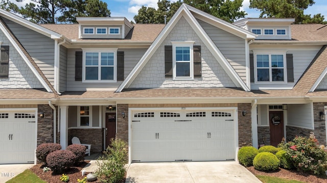 1831 Grandmaster Way, Wake Forest, NC 27587 - view of front of home featuring concrete driveway, stone siding, a garage, and a shingled roof