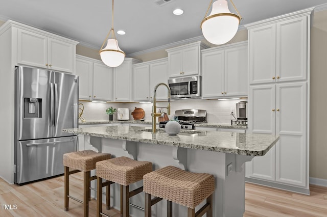 1831 Grandmaster Way, Wake Forest, NC 27587 - kitchen with appliances with stainless steel finishes, decorative backsplash, white cabinetry, light wood-style flooring, and recessed lighting