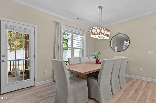 1831 Grandmaster Way, Wake Forest, NC 27587 - dining room featuring light wood-type flooring, plenty of natural light, crown molding, and a chandelier