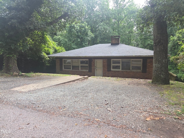 1812 Birmingham Ave, Durham, NC 27704 - ranch-style house with a chimney, brick siding, and driveway