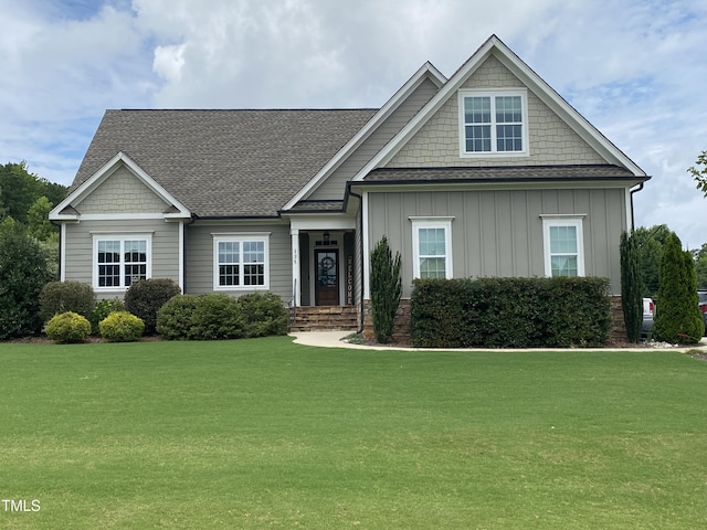 135 Meadow Lake Dr, Youngsville, NC 27596 - craftsman house featuring board and batten siding, a front yard, and roof with shingles