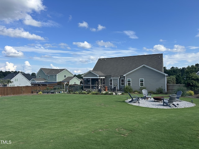 135 Meadow Lake Dr, Youngsville, NC 27596 - rear view of property featuring an outdoor fire pit, a sunroom, a patio, and roof with shingles
