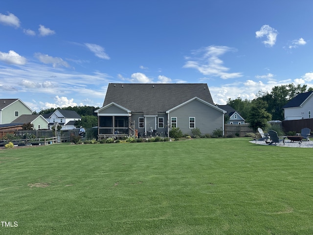 135 Meadow Lake Dr, Youngsville, NC 27596 - rear view of house featuring a fire pit, a sunroom, a patio area, and a shingled roof