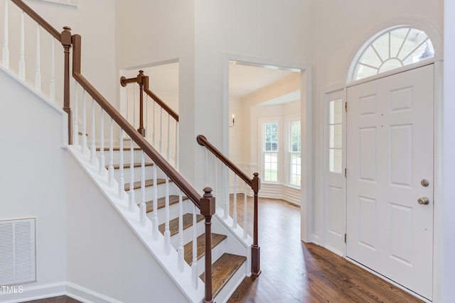 4212 Sprucedale Dr, Raleigh, NC 27613 - foyer entrance featuring dark wood-type flooring, stairway, and a towering ceiling