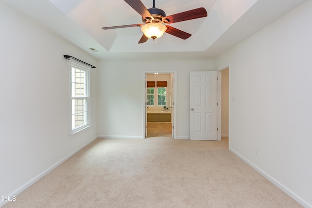 4212 Sprucedale Dr, Raleigh, NC 27613 - unfurnished room featuring a tray ceiling, carpet, and a ceiling fan