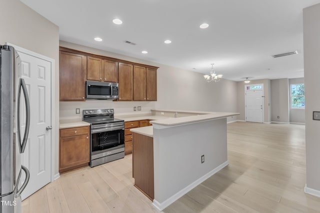 3634 Olympia Dr, Raleigh, NC 27603 - kitchen with stainless steel appliances, a chandelier, light wood-type flooring, light countertops, and brown cabinets