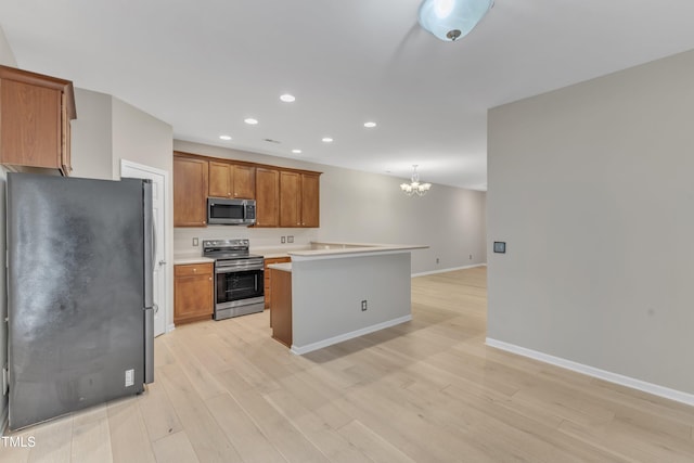 3634 Olympia Dr, Raleigh, NC 27603 - kitchen featuring stainless steel appliances, a chandelier, recessed lighting, brown cabinets, and light countertops