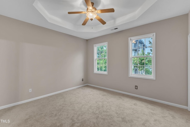 3634 Olympia Dr, Raleigh, NC 27603 - empty room with a raised ceiling, carpet, and a ceiling fan