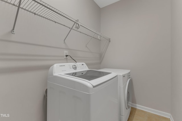 3634 Olympia Dr, Raleigh, NC 27603 - laundry room with washing machine and dryer and light tile patterned floors
