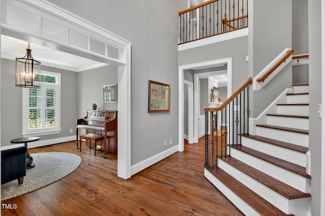 3748 Knollcreek Dr, Apex, NC 27539 - foyer entrance with a chandelier, wood finished floors, stairway, and a high ceiling