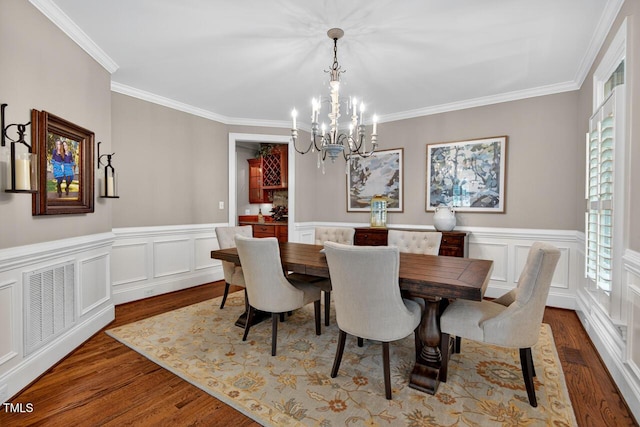 3748 Knollcreek Dr, Apex, NC 27539 - dining room with a chandelier, wood finished floors, ornamental molding, and wainscoting
