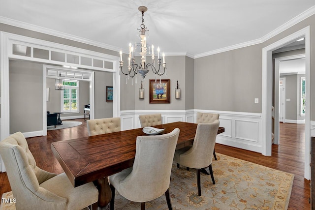 3748 Knollcreek Dr, Apex, NC 27539 - dining space with a chandelier, wood finished floors, crown molding, and a wainscoted wall