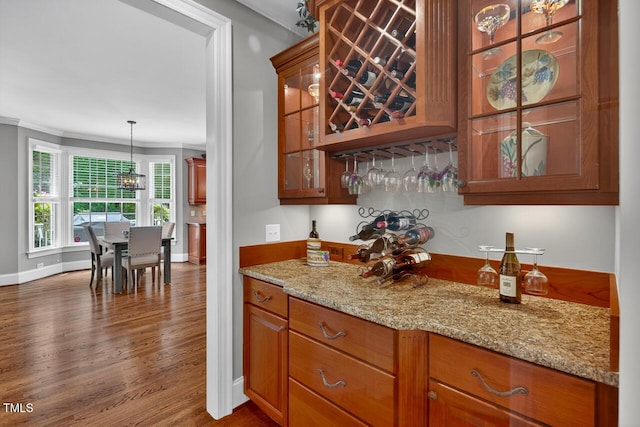 3748 Knollcreek Dr, Apex, NC 27539 - indoor dry bar featuring ornamental molding, dark wood-style floors, a chandelier, and pendant lighting