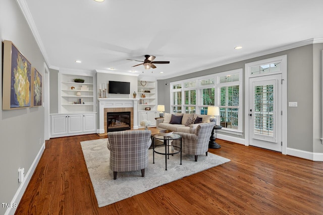 3748 Knollcreek Dr, Apex, NC 27539 - living area with ornamental molding, a ceiling fan, a fireplace, dark wood-type flooring, and recessed lighting