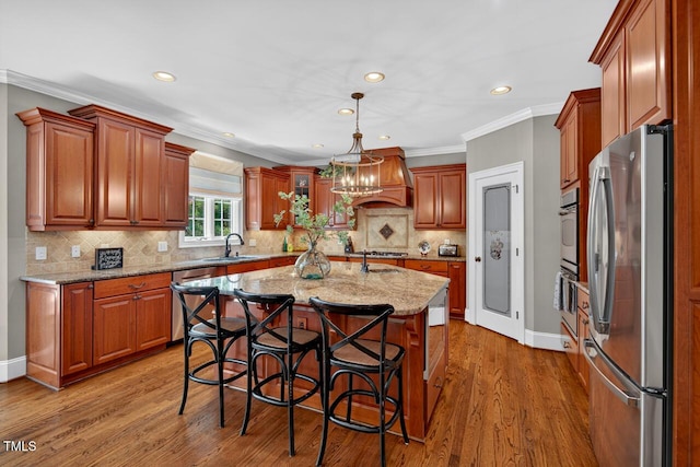 3748 Knollcreek Dr, Apex, NC 27539 - kitchen featuring stainless steel appliances, custom exhaust hood, recessed lighting, light stone countertops, and wood finished floors