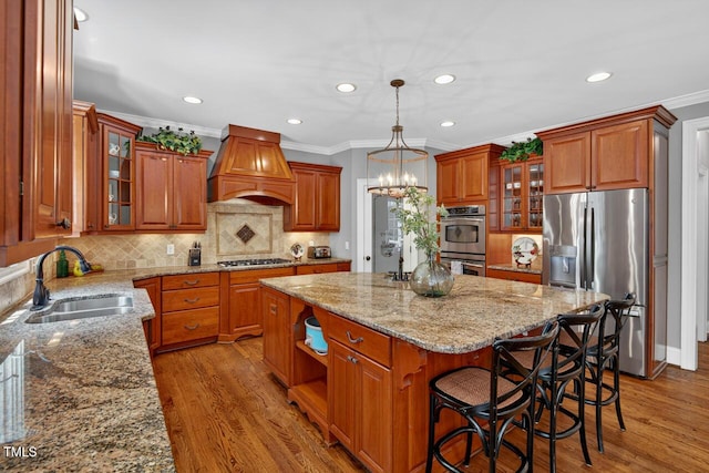 3748 Knollcreek Dr, Apex, NC 27539 - kitchen featuring appliances with stainless steel finishes, premium range hood, a center island, ornamental molding, and recessed lighting