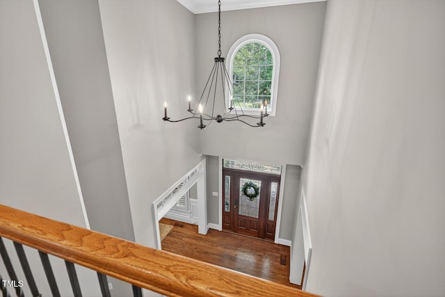 3748 Knollcreek Dr, Apex, NC 27539 - entrance foyer with a chandelier, wood finished floors, a high ceiling, stairs, and ornamental molding