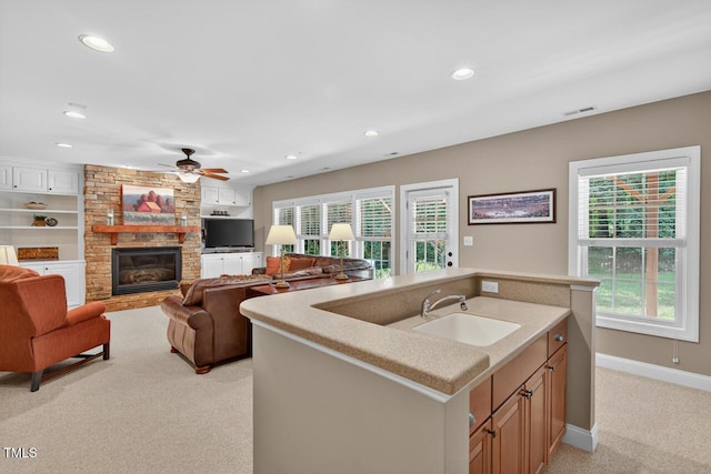 3748 Knollcreek Dr, Apex, NC 27539 - kitchen with light colored carpet, a fireplace, plenty of natural light, recessed lighting, and light countertops