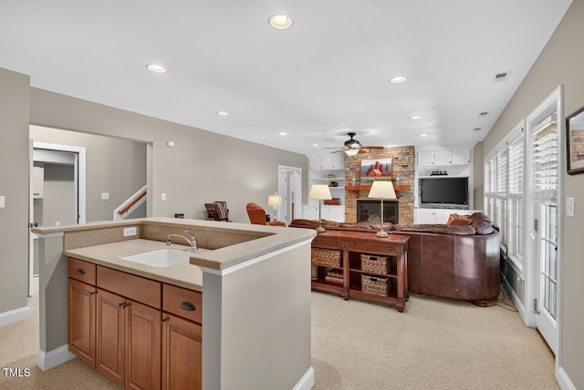 3748 Knollcreek Dr, Apex, NC 27539 - kitchen with ceiling fan, light carpet, a large fireplace, recessed lighting, and light countertops