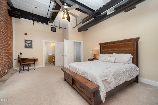 1535 Caraleigh Mills Ct Unit 142, Raleigh, NC 27603 - bedroom with a towering ceiling, light carpet, brick wall, beam ceiling, and ensuite bath